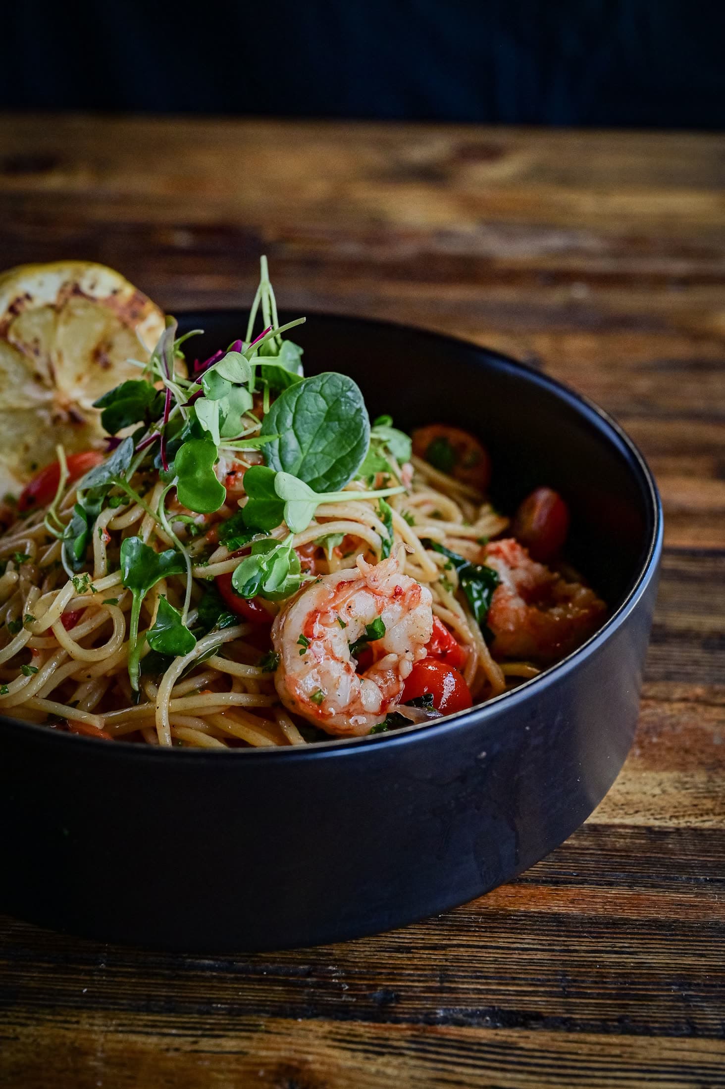 Prawn spaghetti with cherry tomatoes and fresh greens