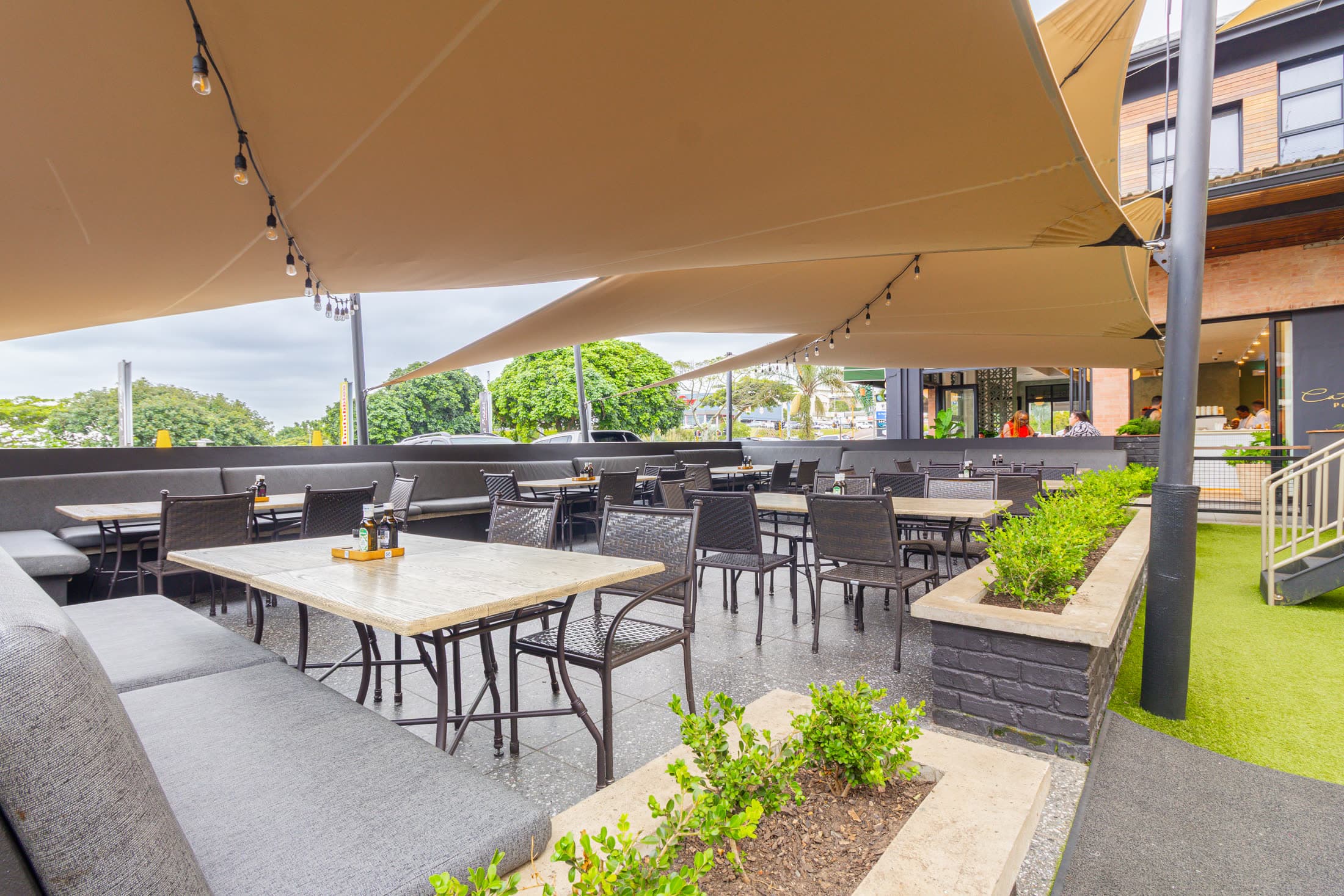 Outside patio area with pergola and sun-umbrellas