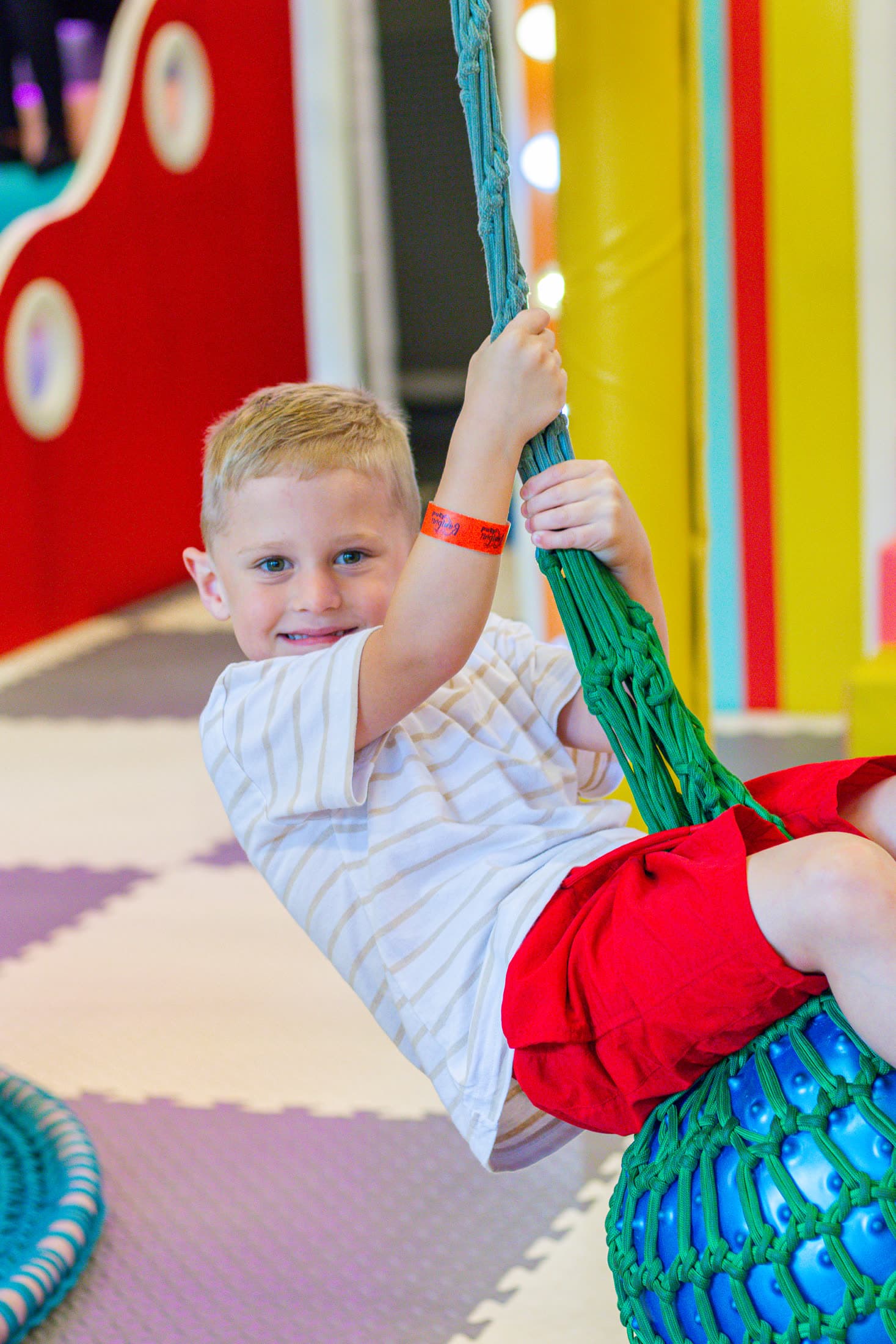 Boy playing on a rope swing at Bambini Land