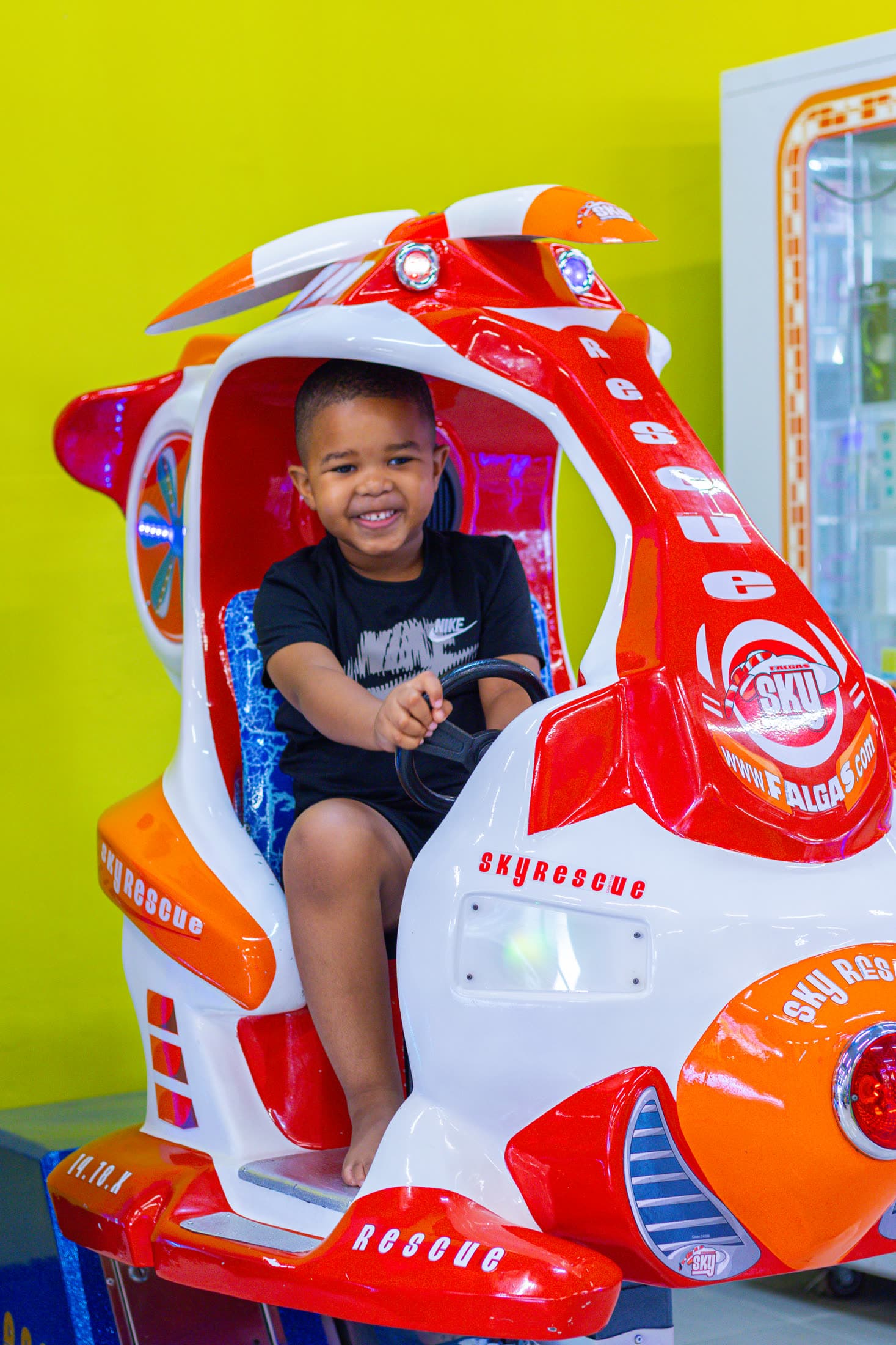 Boy enjoying an arcade ride at Funtubbles