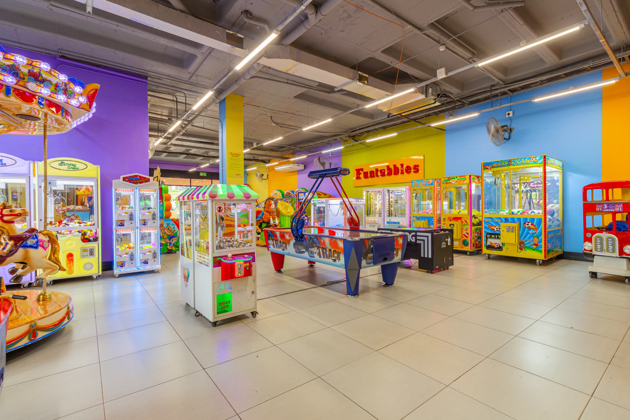Funtubbles arcade area with claw machines and air hockey